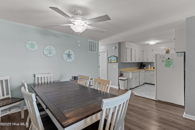 608 Carolina Beach Ave N Unit 3C, Carolina Beach, NC 28428 - dining space with a ceiling fan, baseboards, and light wood-style floors
