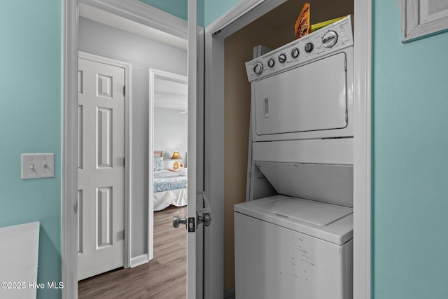 608 Carolina Beach Ave N Unit 3C, Carolina Beach, NC 28428 - laundry room featuring stacked washer / drying machine and wood finished floors