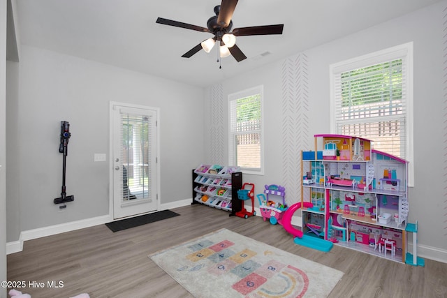playroom with wood finished floors, baseboards, and ceiling fan