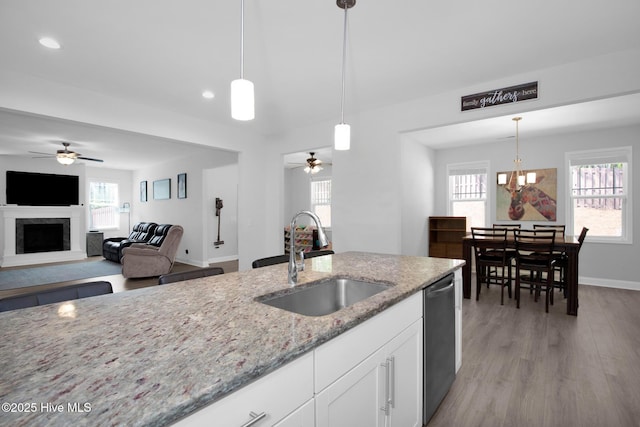 kitchen featuring a sink, a ceiling fan, dishwashing machine, white cabinetry, and recessed lighting