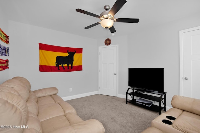 carpeted living room featuring a ceiling fan and baseboards