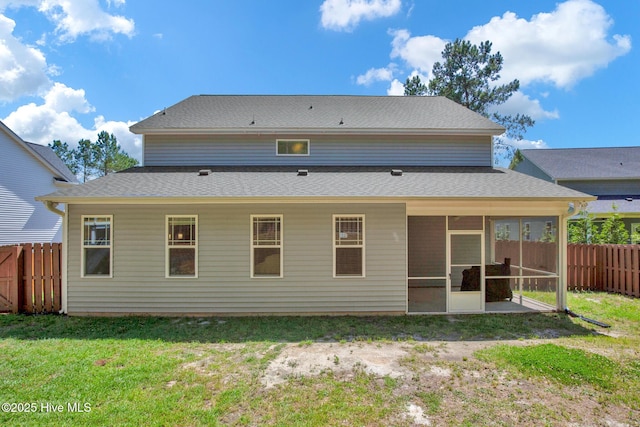 rear view of house featuring a sunroom and a shingled roof