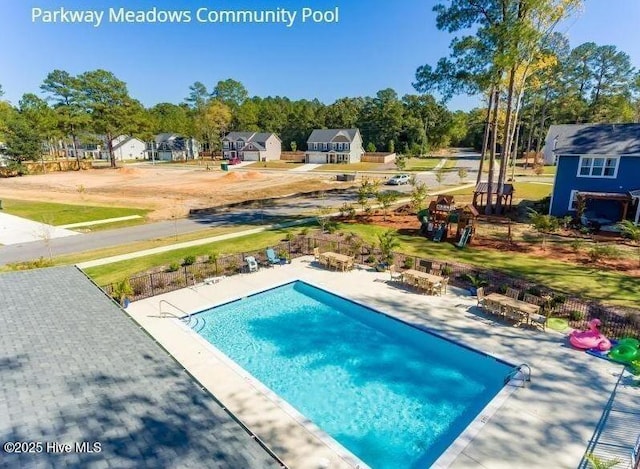 view of pool featuring fence and a patio area