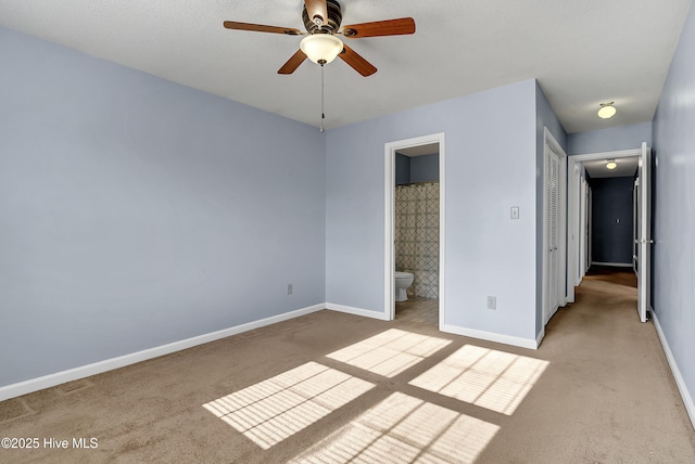 100 Sycamore Ln, Elizabeth City, NC 27909 - unfurnished bedroom with light carpet, baseboards, and connected bathroom
