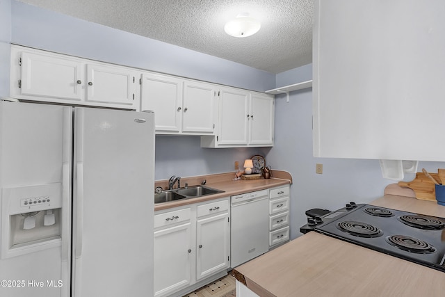 100 Sycamore Ln, Elizabeth City, NC 27909 - kitchen featuring white appliances, a textured ceiling, a sink, white cabinets, and light countertops