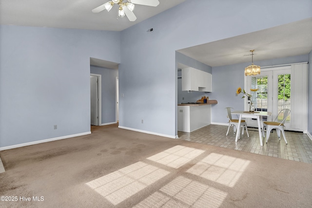100 Sycamore Ln, Elizabeth City, NC 27909 - carpeted living room featuring baseboards, a ceiling fan, lofted ceiling, and a chandelier