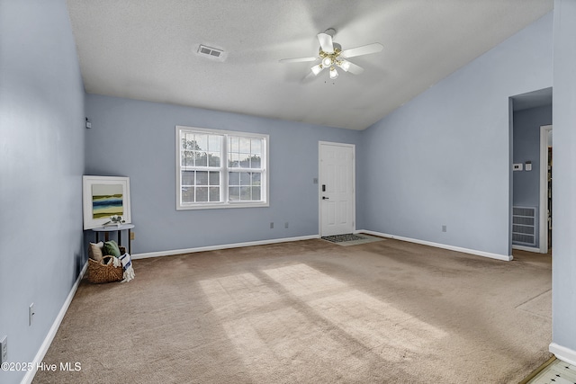 100 Sycamore Ln, Elizabeth City, NC 27909 - unfurnished living room with a ceiling fan, carpet flooring, lofted ceiling, and baseboards
