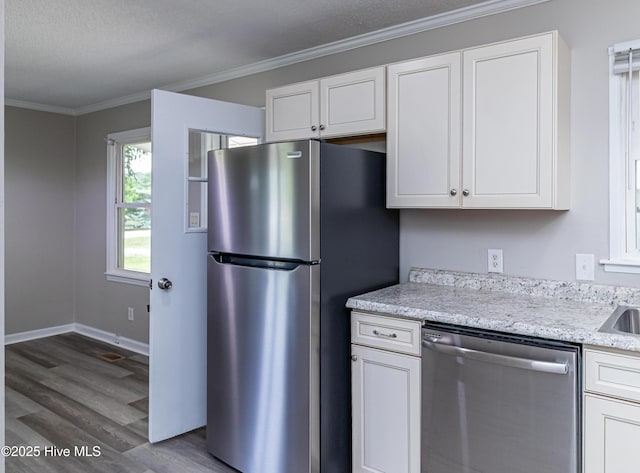 204 Fox Dr, Dudley, NC 28333 - kitchen with stainless steel appliances, dark wood-style floors, crown molding, white cabinetry, and baseboards