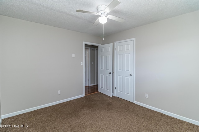 204 Fox Dr, Dudley, NC 28333 - unfurnished bedroom with dark colored carpet, baseboards, a textured ceiling, and a ceiling fan