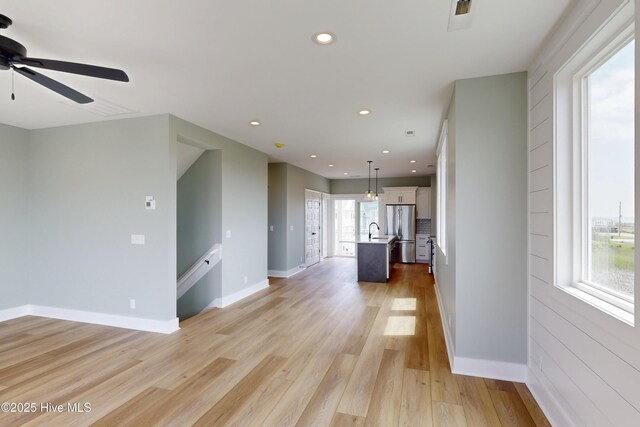 130 Sea Oaks Ct, North Topsail Beach, NC 28460 - unfurnished living room with light wood-type flooring, recessed lighting, a ceiling fan, a sink, and baseboards