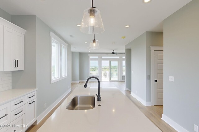 130 Sea Oaks Ct, North Topsail Beach, NC 28460 - kitchen featuring a sink, recessed lighting, light countertops, white cabinets, and decorative light fixtures