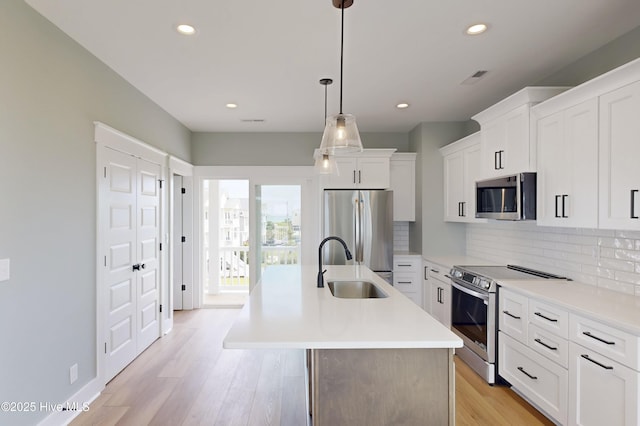 130 Sea Oaks Ct, North Topsail Beach, NC 28460 - kitchen featuring appliances with stainless steel finishes, a sink, backsplash, an island with sink, and recessed lighting