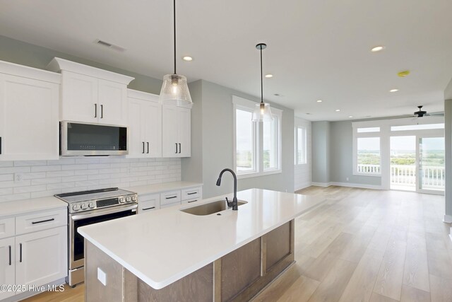 130 Sea Oaks Ct, North Topsail Beach, NC 28460 - kitchen featuring stainless steel appliances, a sink, decorative backsplash, a kitchen island with sink, and recessed lighting