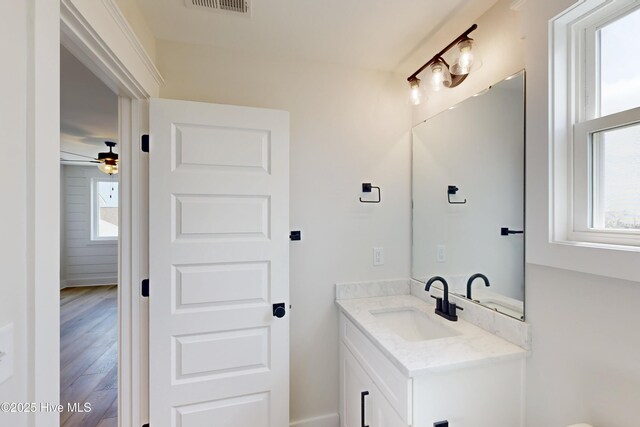 130 Sea Oaks Ct, North Topsail Beach, NC 28460 - bathroom featuring vanity, wood finished floors, and a ceiling fan