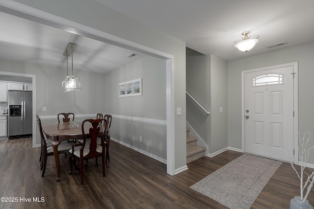 7810 Olde Pond Rd, Wilmington, NC 28411 - dining space with dark wood-style flooring, stairs, and baseboards