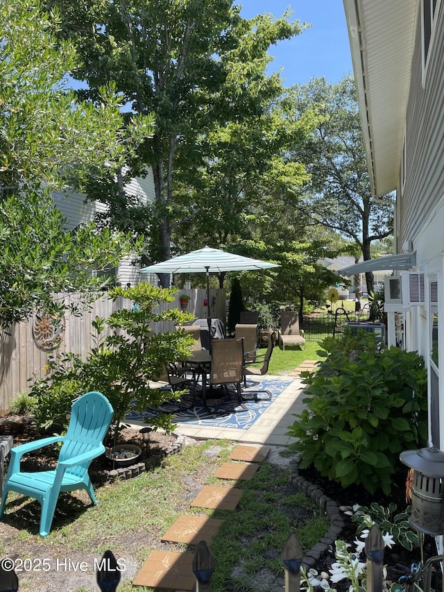 129 NE 36th St, Oak Island, NC 28465 - fenced backyard featuring a patio area