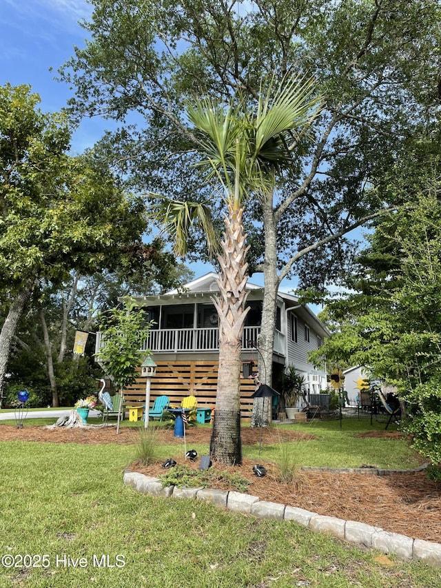 129 NE 36th St, Oak Island, NC 28465 - view of front of property featuring a sunroom