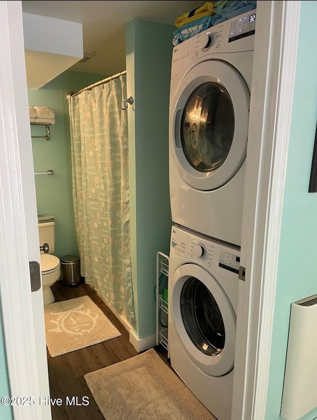 129 NE 36th St, Oak Island, NC 28465 - washroom featuring stacked washer / dryer and wood finished floors
