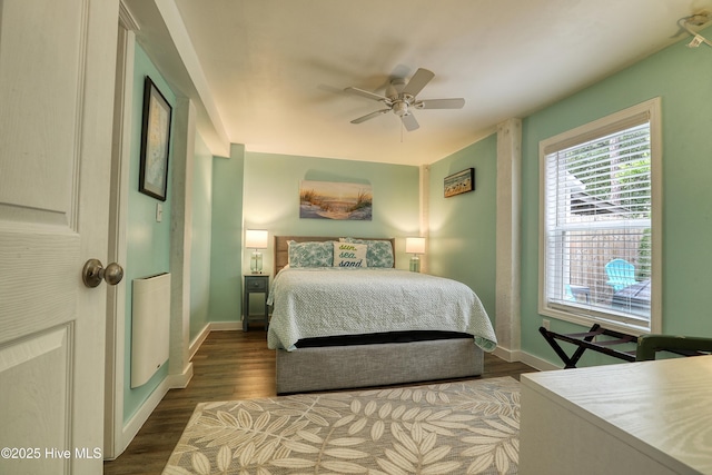 129 NE 36th St, Oak Island, NC 28465 - bedroom featuring baseboards, wood finished floors, and a ceiling fan