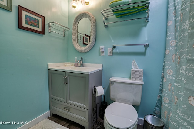 129 NE 36th St, Oak Island, NC 28465 - full bath featuring baseboards, vanity, toilet, and wood finished floors