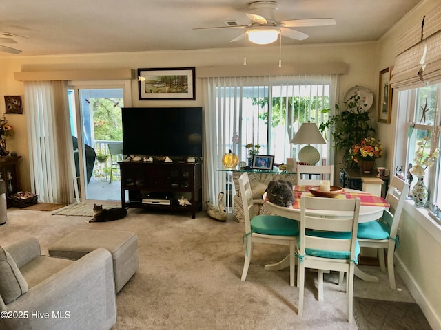 129 NE 36th St, Oak Island, NC 28465 - carpeted dining area with ceiling fan and healthy amount of natural light
