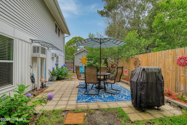 129 NE 36th St, Oak Island, NC 28465 - fenced backyard featuring a patio, outdoor dining space, and area for grilling