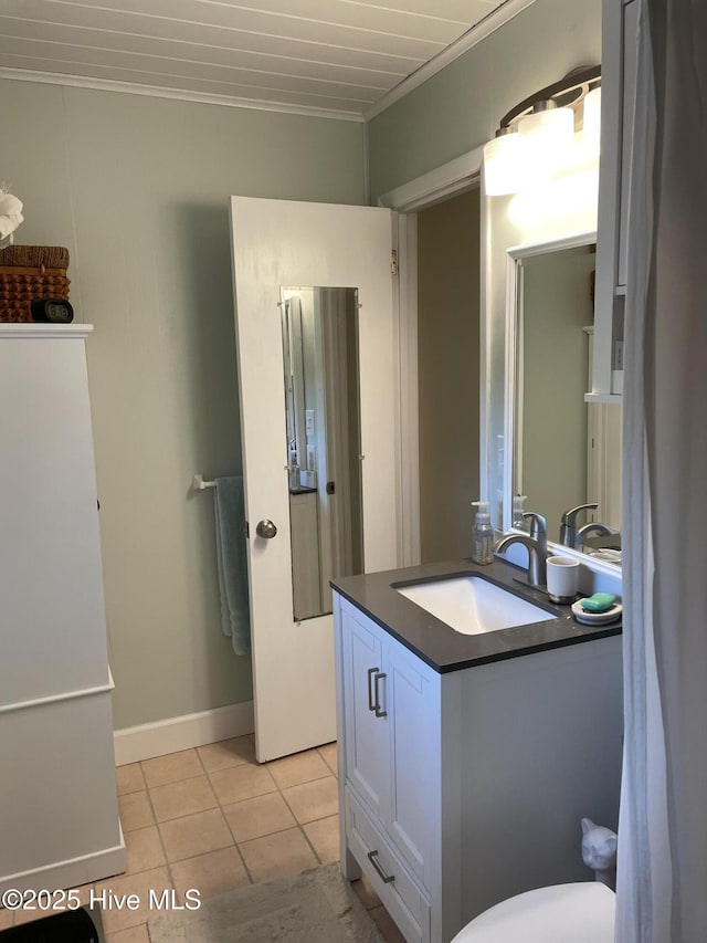 129 NE 36th St, Oak Island, NC 28465 - bathroom with ornamental molding, vanity, and tile patterned flooring