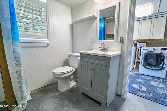 129 NE 36th St, Oak Island, NC 28465 - bathroom with washer / dryer, unfinished concrete floors, vanity, toilet, and curtained shower