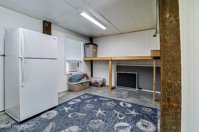 129 NE 36th St, Oak Island, NC 28465 - kitchen featuring freestanding refrigerator, unfinished concrete flooring, and cooling unit