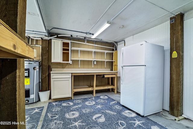 129 NE 36th St, Oak Island, NC 28465 - below grade area featuring freestanding refrigerator and electric water heater