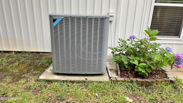 129 NE 36th St, Oak Island, NC 28465 - exterior view of central air condition unit and board and batten siding