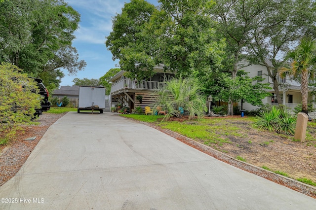 129 NE 36th St, Oak Island, NC 28465 - obstructed view of property with concrete driveway