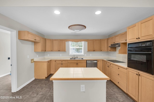 kitchen featuring black appliances, light brown cabinets, tile counters, a sink, and under cabinet range hood