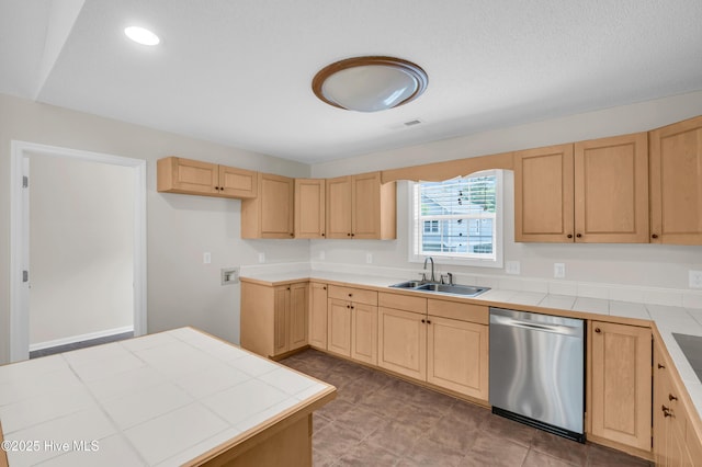 kitchen with stainless steel dishwasher, a sink, light brown cabinetry, tile countertops, and recessed lighting