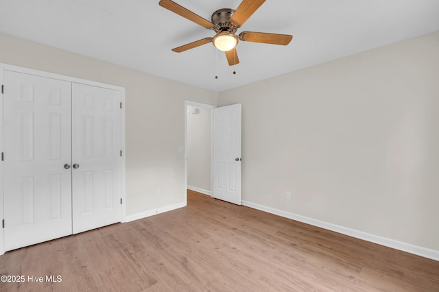 unfurnished bedroom with baseboards, light wood-style flooring, a closet, and ceiling fan