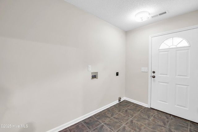 laundry area featuring a textured ceiling, baseboards, and hookup for a washing machine