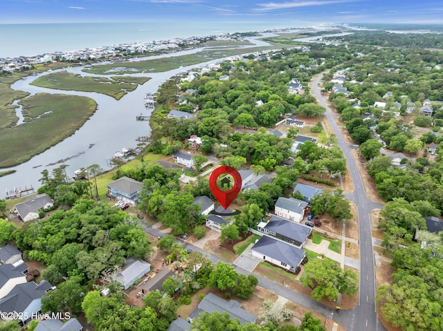 aerial view of property's location featuring a large body of water and nearby suburban area