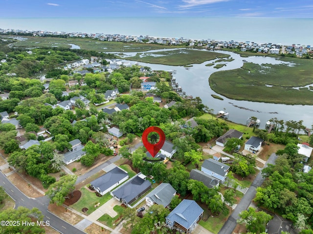 aerial overview of property's location with a nearby body of water and nearby suburban area