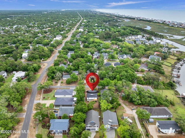 aerial view of residential area featuring a large body of water