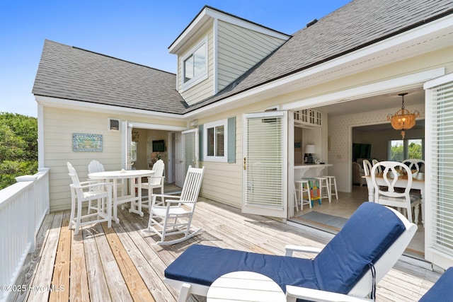 wooden deck featuring outdoor dining space