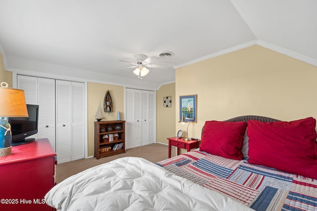 bedroom featuring multiple closets, carpet floors, vaulted ceiling, a ceiling fan, and baseboards