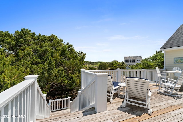 wooden deck featuring outdoor dining area