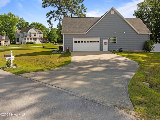 view of front of home featuring crawl space, driveway, an attached garage, and a front yard