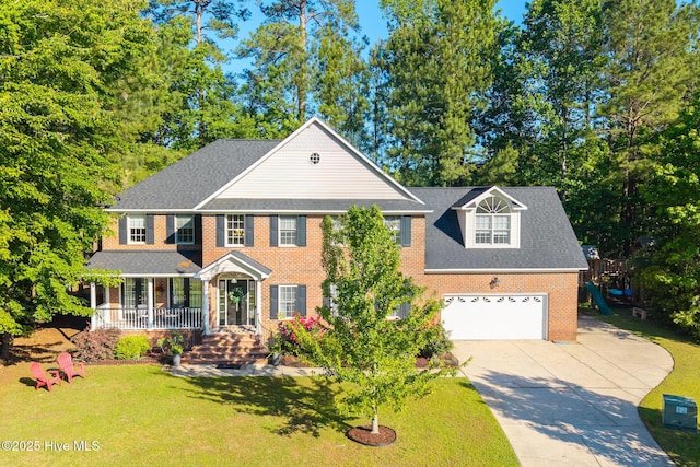 view of front of house featuring driveway, brick siding, a front lawn, and a porch
