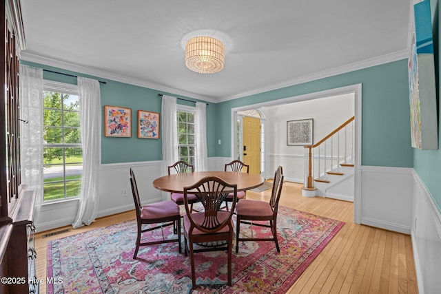 1005 Cambridge Ct, Trent Woods, NC 28562 - dining space with wainscoting, healthy amount of natural light, stairs, light wood finished floors, and ornamental molding