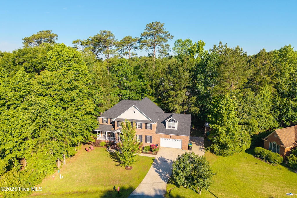 view of subject property featuring a heavily wooded area