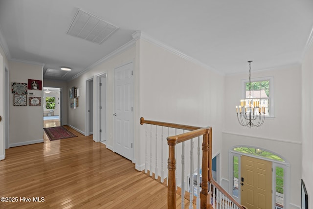 1005 Cambridge Ct, Trent Woods, NC 28562 - hall featuring a chandelier, light wood-type flooring, ornamental molding, baseboards, and an upstairs landing