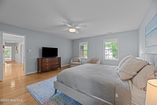 1005 Cambridge Ct, Trent Woods, NC 28562 - bedroom featuring wood finished floors, a textured ceiling, a ceiling fan, and baseboards