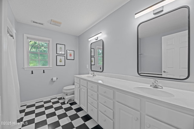 1005 Cambridge Ct, Trent Woods, NC 28562 - full bathroom featuring plenty of natural light, tile patterned floors, toilet, double vanity, and a textured ceiling