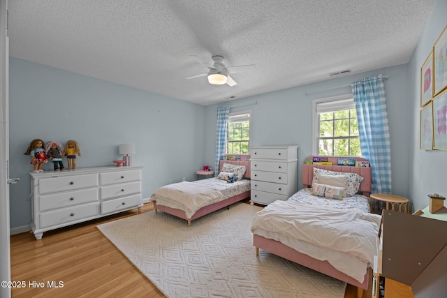 1005 Cambridge Ct, Trent Woods, NC 28562 - bedroom with a textured ceiling, light wood-type flooring, and a ceiling fan